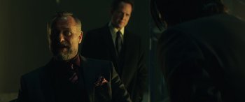 Movie still from “John Wick” (2014), directed by Chad Stahelski – A group of men and women standing next to each other; Medium shot, Over the shoulder angle