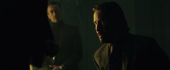 Movie still from “John Wick” (2014), directed by Chad Stahelski – A man in a black jacket and a man in a black suit; Medium shot, Over the shoulder angle