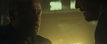 Movie still from “John Wick” (2014), directed by Chad Stahelski – A person wearing a suit and tie; Close Up shot, Over the shoulder angle