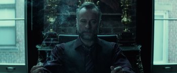 Movie still from “John Wick” (2014), directed by Chad Stahelski – A man sitting in a chair with a cigarette in his mouth; Close Up shot, Low angle
