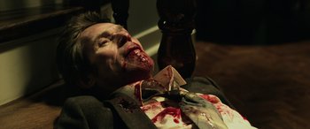 Movie still from “John Wick” (2014), directed by Chad Stahelski – A man in a suit and tie covered in blood; Close Up shot, High angle