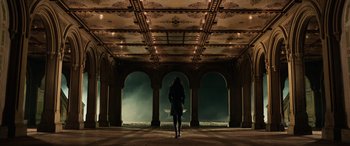 Movie still from “John Wick” (2014), directed by Chad Stahelski – A woman standing in a room with arches and lights; Extreme Wide shot, Low angle