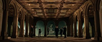 Movie still from “John Wick” (2014), directed by Chad Stahelski – A group of men standing in front of an ornate fountain; Extreme Wide shot, High angle