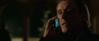 Movie still from “John Wick” (2014), directed by Chad Stahelski – An older man talking on a cell phone; Close Up shot, Low angle