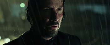 Movie still from “John Wick” (2014), directed by Chad Stahelski – A man in a black shirt and a black tie; Close Up shot, Low angle