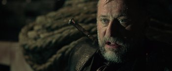 Movie still from “John Wick” (2014), directed by Chad Stahelski – An older man with a beard and a pipe in his mouth; Close Up shot, Low angle
