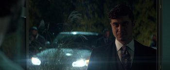 Movie still from “John Wick: Chapter 2” (2017), directed by Chad Stahelski – A man standing in front of a car at night; Close Up shot, Over the shoulder angle