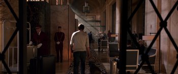 Movie still from “John Wick: Chapter 2” (2017), directed by Chad Stahelski – A man walking down a hall way with a dog; Wide shot, Over the shoulder angle