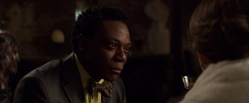 Movie still from “John Wick: Chapter 2” (2017), directed by Chad Stahelski – A person wearing a suit and a bow tie; Close Up shot, Low angle