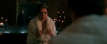 Movie still from “John Wick: Chapter 2” (2017), directed by Chad Stahelski – A woman wearing a white fur coat looking in a mirror; Close Up shot, Over the shoulder angle