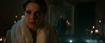 Movie still from “John Wick: Chapter 2” (2017), directed by Chad Stahelski – A person wearing a white coat; Close Up shot, Over the shoulder angle