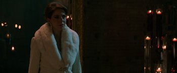 Movie still from “John Wick: Chapter 2” (2017), directed by Chad Stahelski – A woman in a white coat standing in front of a mirror; Close Up shot, Over the shoulder angle