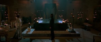 Movie still from “John Wick: Chapter 2” (2017), directed by Chad Stahelski – A man standing in front of an indoor fountain; Extreme Wide shot, High angle