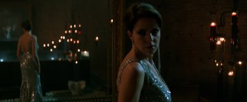 Movie still from “John Wick: Chapter 2” (2017), directed by Chad Stahelski – A woman in a silver dress standing in front of a mirror; Medium shot, Over the shoulder angle