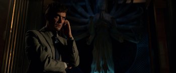 Movie still from “John Wick: Chapter 2” (2017), directed by Chad Stahelski – A man in a suit is on a cell phone; Medium shot, Low angle