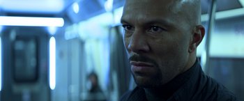 Movie still from “John Wick: Chapter 2” (2017), directed by Chad Stahelski – A man's face in a dark room; Close Up shot, Over the shoulder angle