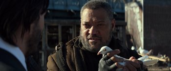 Movie still from “John Wick: Chapter 2” (2017), directed by Chad Stahelski – An older man holding a remote control in his hand; Close Up shot, Low angle