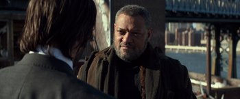 Movie still from “John Wick: Chapter 2” (2017), directed by Chad Stahelski – An older man with a beard is talking to a younger man; Close Up shot, Over the shoulder angle