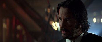 Movie still from “John Wick: Chapter 2” (2017), directed by Chad Stahelski – A person wearing a suit and tie; Close Up shot, Over the shoulder angle