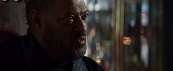 Movie still from “John Wick: Chapter 2” (2017), directed by Chad Stahelski – A person wearing a suit and tie; Close Up shot, Over the shoulder angle