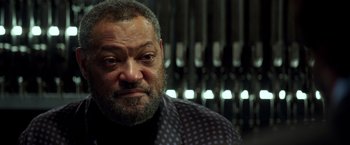 Movie still from “John Wick: Chapter 2” (2017), directed by Chad Stahelski – An older man with a beard and a jacket on; Close Up shot, Low angle