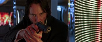 Movie still from “John Wick: Chapter 2” (2017), directed by Chad Stahelski – A man holding a gun in his hand; Close Up shot, Low angle