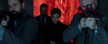 Movie still from “John Wick: Chapter 2” (2017), directed by Chad Stahelski – A man and a woman standing next to each other in front of a red screen; Close Up shot, Low angle