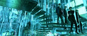 Movie still from “John Wick: Chapter 2” (2017), directed by Chad Stahelski – A man standing on some stairs in a room; Wide shot, Low angle