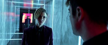 Movie still from “John Wick: Chapter 2” (2017), directed by Chad Stahelski – A man in a purple jacket looking at another man in a purple jacket; Close Up shot, Over the shoulder angle