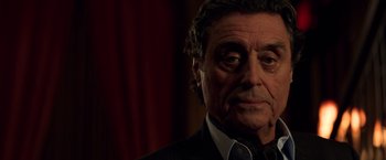 Movie still from “John Wick: Chapter 2” (2017), directed by Chad Stahelski – An older man wearing a suit and a tie; Close Up shot, Low angle