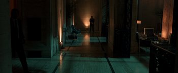 Movie still from “John Wick: Chapter 2” (2017), directed by Chad Stahelski – A man standing in a dark room with a light shining on him; Extreme Wide shot, High angle