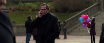 Movie still from “John Wick: Chapter 2” (2017), directed by Chad Stahelski – A man in a black coat talking on a cell phone; Medium shot, Low angle