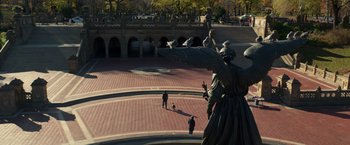 Movie still from “John Wick: Chapter 2” (2017), directed by Chad Stahelski – People walking on a plaza in front of a building; Extreme Wide shot, High angle
