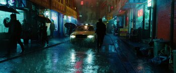 Movie still from “John Wick: Chapter 3 - Parabellum” (2019), directed by Chad Stahelski – A man walking down the street in the rain with an umbrella; Extreme Wide shot, High angle