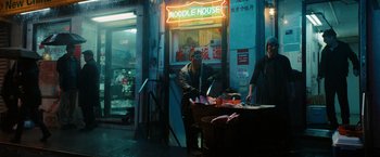 Movie still from “John Wick: Chapter 3 - Parabellum” (2019), directed by Chad Stahelski – A man and a woman standing in front of a noodle house; Wide shot, Low angle