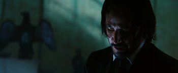 Movie still from “John Wick: Chapter 3 - Parabellum” (2019), directed by Chad Stahelski – A person wearing a suit and tie; Close Up shot, Low angle