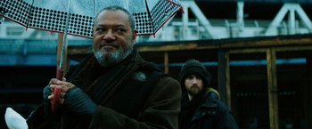 Movie still from “John Wick: Chapter 3 - Parabellum” (2019), directed by Chad Stahelski – A man holding an umbrella while standing next to another man; Close Up shot, Low angle