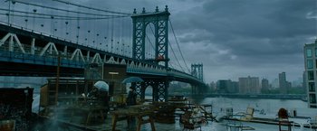 Movie still from “John Wick: Chapter 3 - Parabellum” (2019), directed by Chad Stahelski – A man standing under an umbrella near a bridge; Extreme Wide shot, Low angle