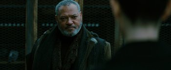 Movie still from “John Wick: Chapter 3 - Parabellum” (2019), directed by Chad Stahelski – An older man wearing a coat and a scarf; Close Up shot, Over the shoulder angle