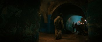 Movie still from “John Wick: Chapter 3 - Parabellum” (2019), directed by Chad Stahelski – A man walking in a tunnel with a sword in his hand; Wide shot, Low angle