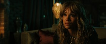 Movie still from “John Wick: Chapter 3 - Parabellum” (2019), directed by Chad Stahelski – A woman sitting on a couch in a living room; Close Up shot, Over the shoulder angle