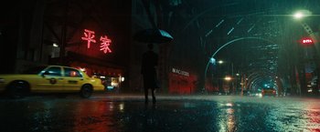 Movie still from “John Wick: Chapter 3 - Parabellum” (2019), directed by Chad Stahelski – A person holding an umbrella while standing in the rain at night; Extreme Wide shot, Low angle