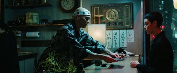 Movie still from “John Wick: Chapter 3 - Parabellum” (2019), directed by Chad Stahelski – A man in a kimono is playing a video game; Medium shot, Low angle