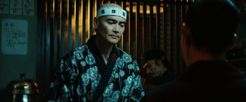 Movie still from “John Wick: Chapter 3 - Parabellum” (2019), directed by Chad Stahelski – A man wearing a white hat and a black and white robe; Close Up shot, Low angle