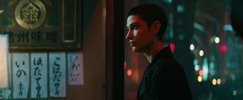 Movie still from “John Wick: Chapter 3 - Parabellum” (2019), directed by Chad Stahelski – A woman with short hair is looking out a window; Close Up shot, Over the shoulder angle