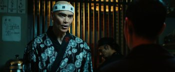 Movie still from “John Wick: Chapter 3 - Parabellum” (2019), directed by Chad Stahelski – A man wearing a kimono and a white hat; Close Up shot, Low angle