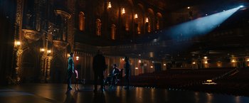 Movie still from “John Wick: Chapter 3 - Parabellum” (2019), directed by Chad Stahelski – A group of people sitting in a room with lights on; Extreme Wide shot, High angle