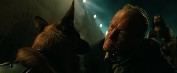 Movie still from “John Wick: Chapter 3 - Parabellum” (2019), directed by Chad Stahelski – An old man and a dog in a dark room; Close Up shot, Over the shoulder angle