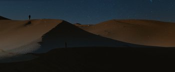 Movie still from “John Wick: Chapter 3 - Parabellum” (2019), directed by Chad Stahelski – A person standing on a hill at night; Extreme Wide shot, Low angle