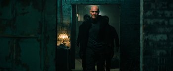 Movie still from “John Wick: Chapter 3 - Parabellum” (2019), directed by Chad Stahelski – A man in a black jacket walking through a room; Medium shot, Low angle